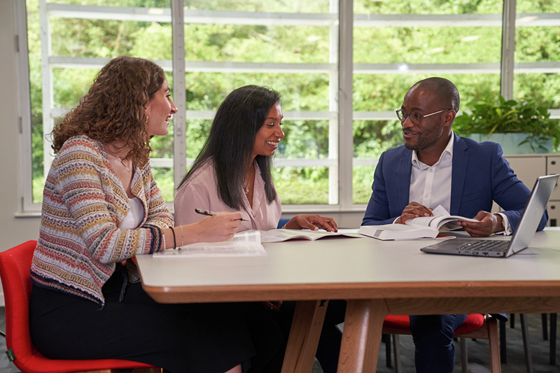 Group of employees speaking and laughing