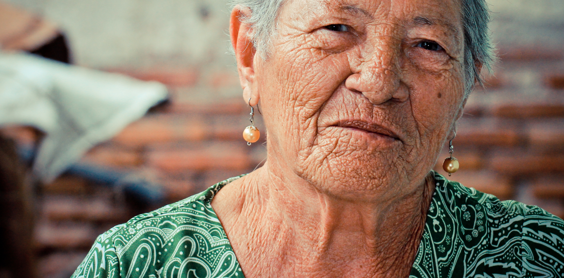 An elderly woman smiling at the camera